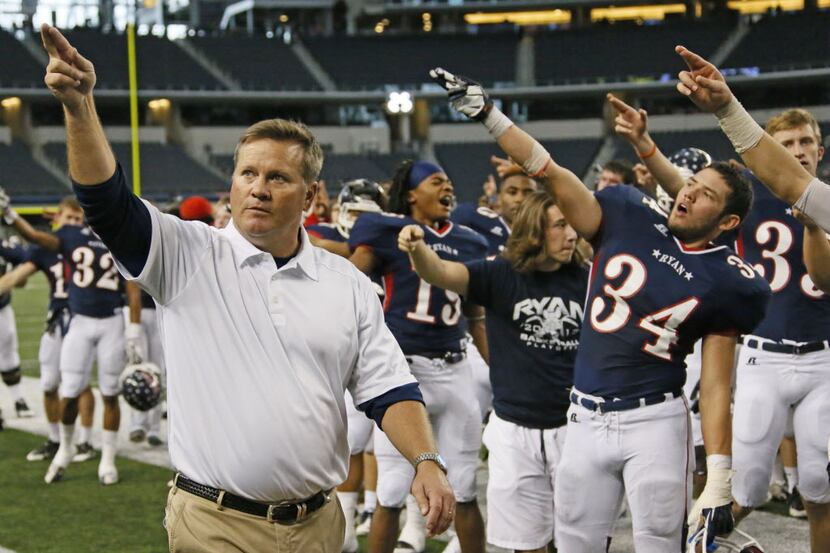 Denton Ryan head coach Joey Florence celebrates with his team after their 34-33 win during...