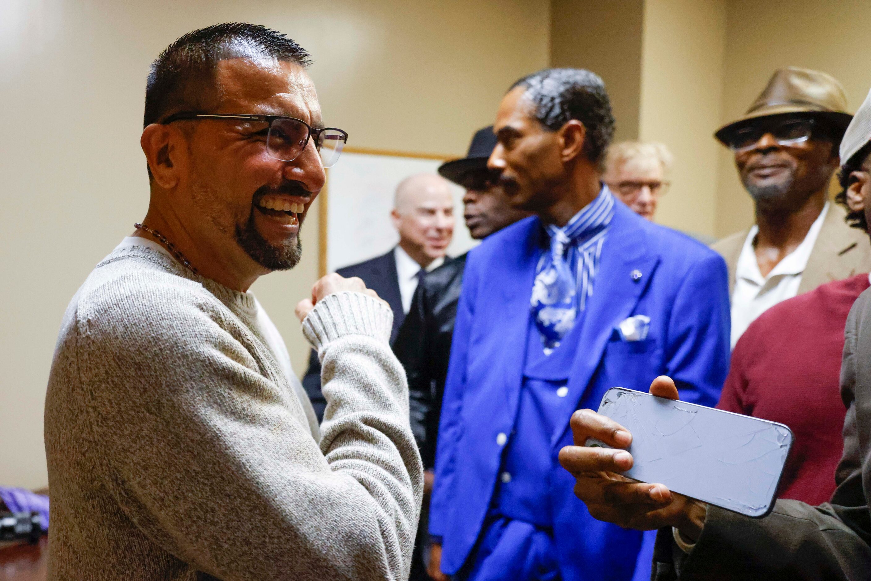 Martin Santillan laughs with other exonerees outside of the courtroom after he was formally...