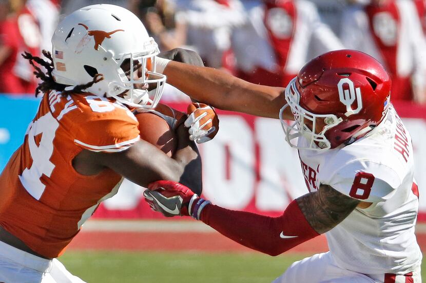 Texas Longhorns wide receiver Lil'Jordan Humphrey (84) is grabbed by Oklahoma Sooners safety...