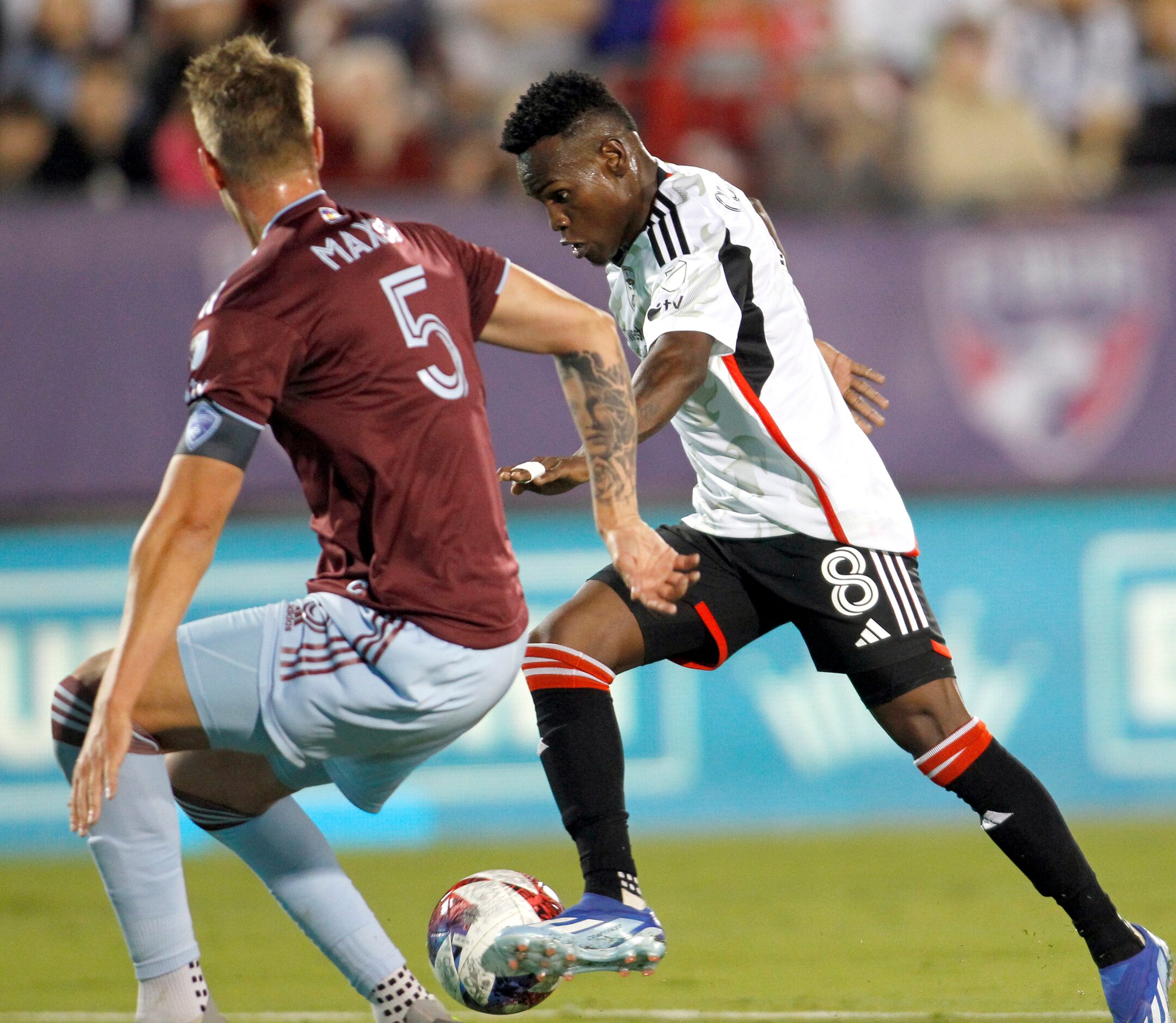 FC Dallas attacker Jader Obrian (8) maneuvers the ball against the defense of Colorado...