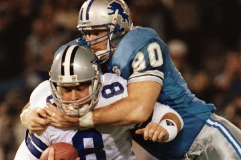 Dallas Cowboys quarterback Troy Aikman (8) is sacked in the third quarter by Detroit Lions...