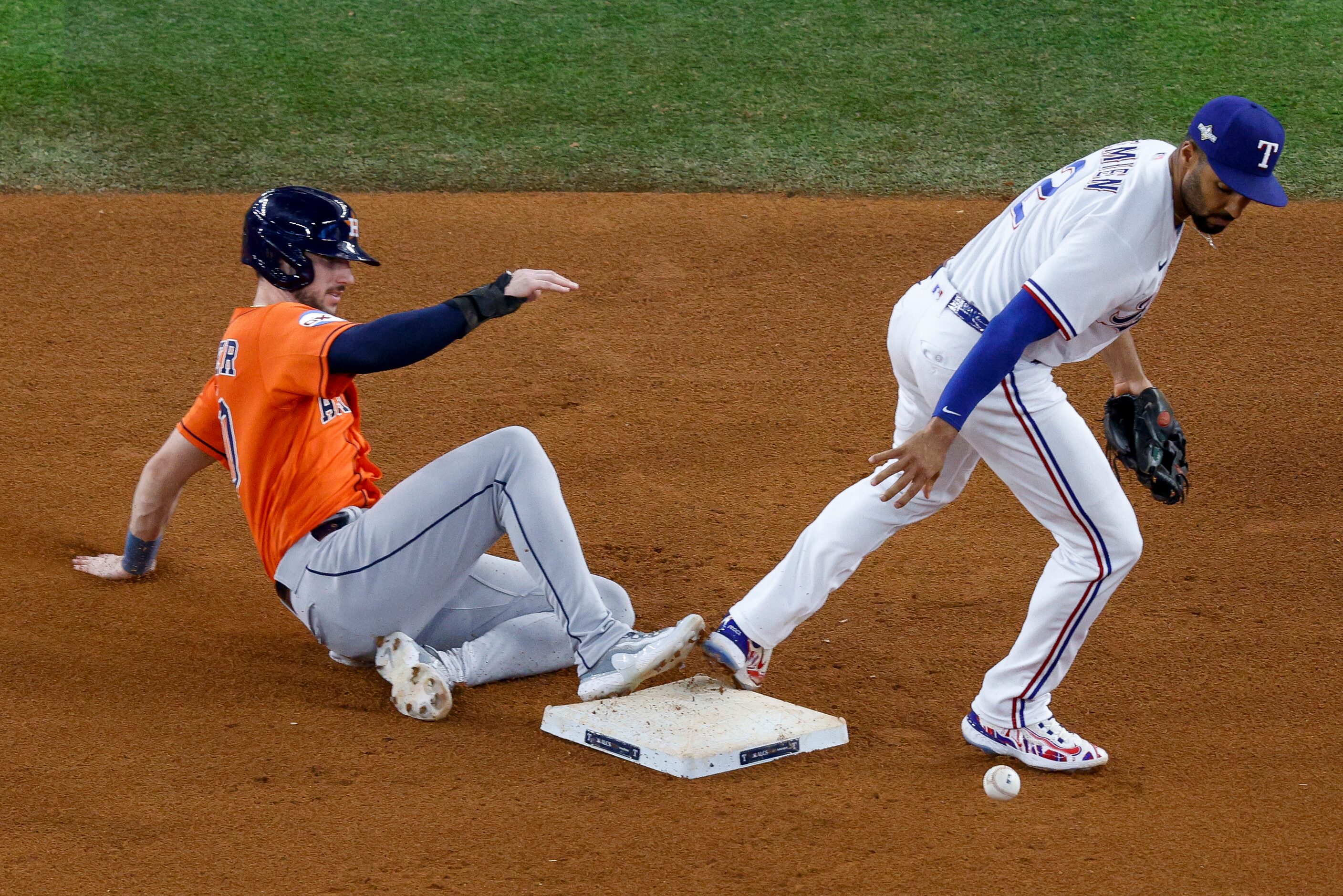 Texas Rangers second baseman Marcus Semien (2) drops a throw from shortstop Corey Seager as...