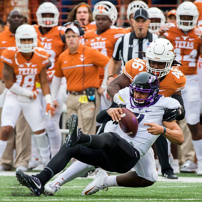 FILE - TCU quarterback Kenny Hill (7) is tackled for a loss by Texas linebacker Malik...