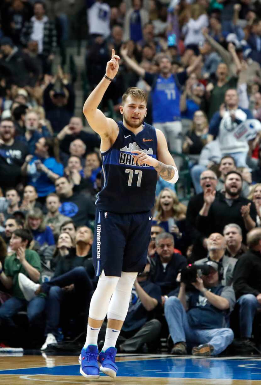 Dallas Mavericks rookie Luka Doncic reacts after hitting a basket during the fourth quarter...