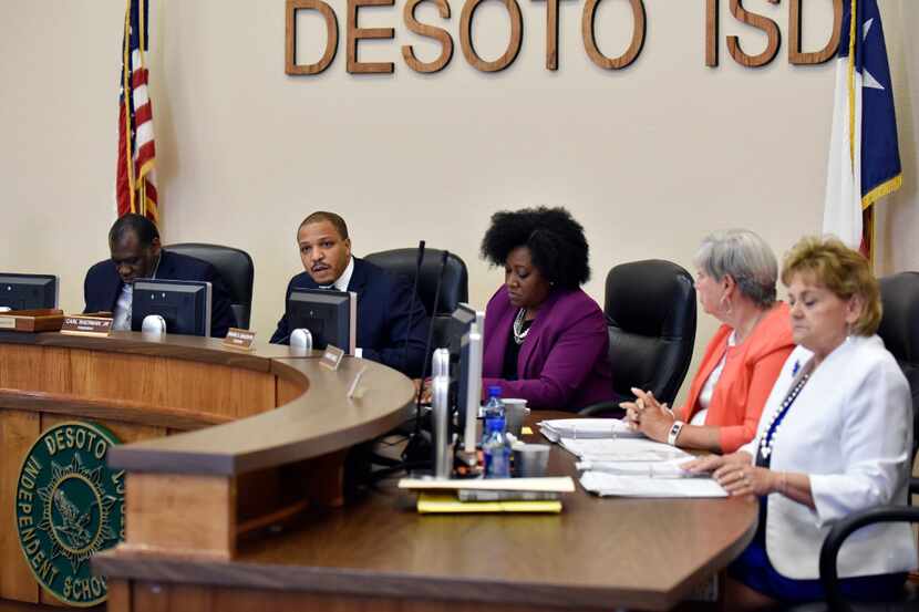 Carl Sherman Jr., DeSoto ISD president, second from left, conducts a school board meeting to...
