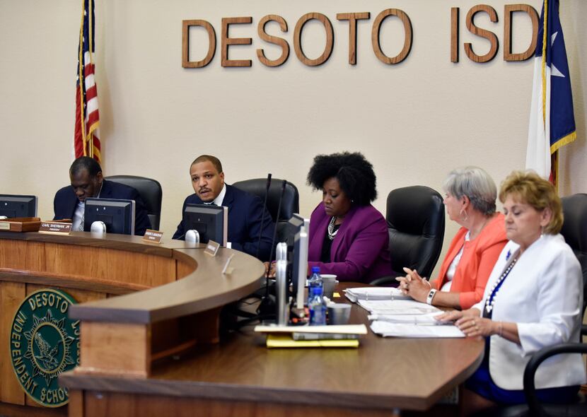 Carl Sherman Jr., DeSoto ISD president, second from left, conducts a school board meeting to...
