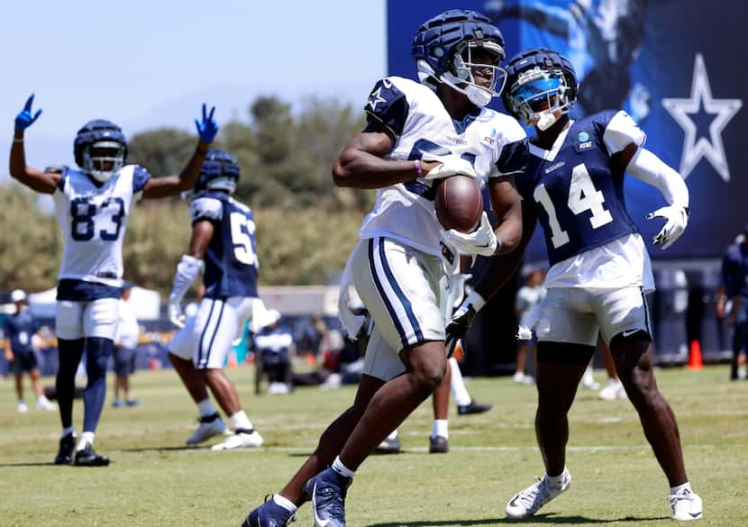 Dallas Cowboys tight end John Stephens (81,center) secures a touchdown pass as he’s covered...