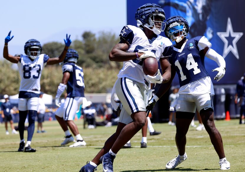 Dallas Cowboys tight end John Stephens (81,center) secures a touchdown pass as he’s covered...