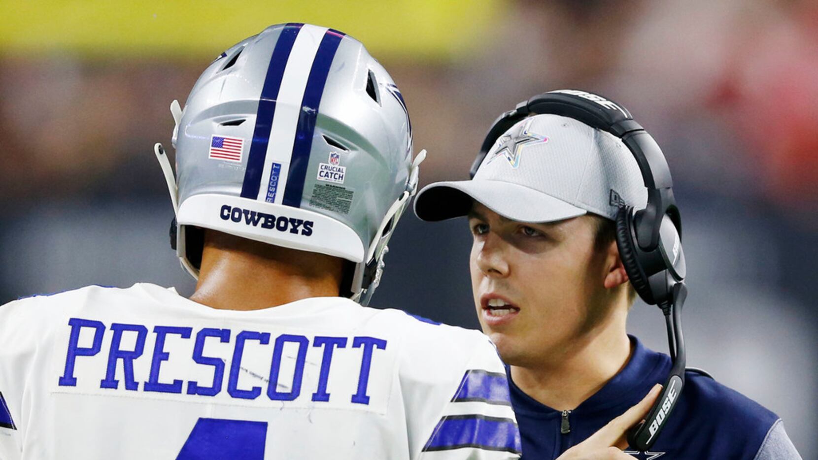 FILE - Cowboys quarterbacks coach Kellen Moore talks to quarterback Dak Prescott (4)  during...