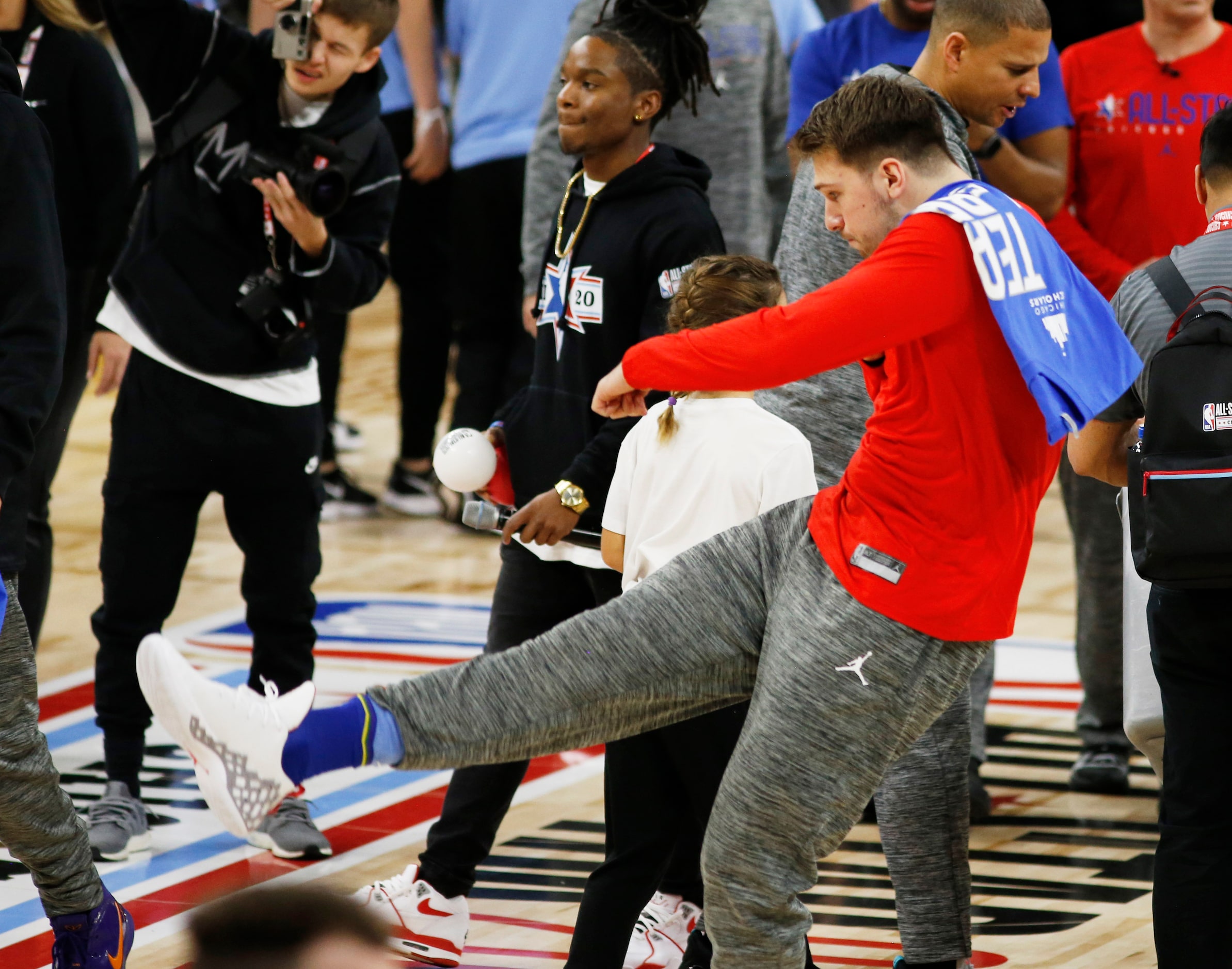 Team LeBron's Dallas Mavericks forward Luka Doncic (77) throws a ball in the stands at the...