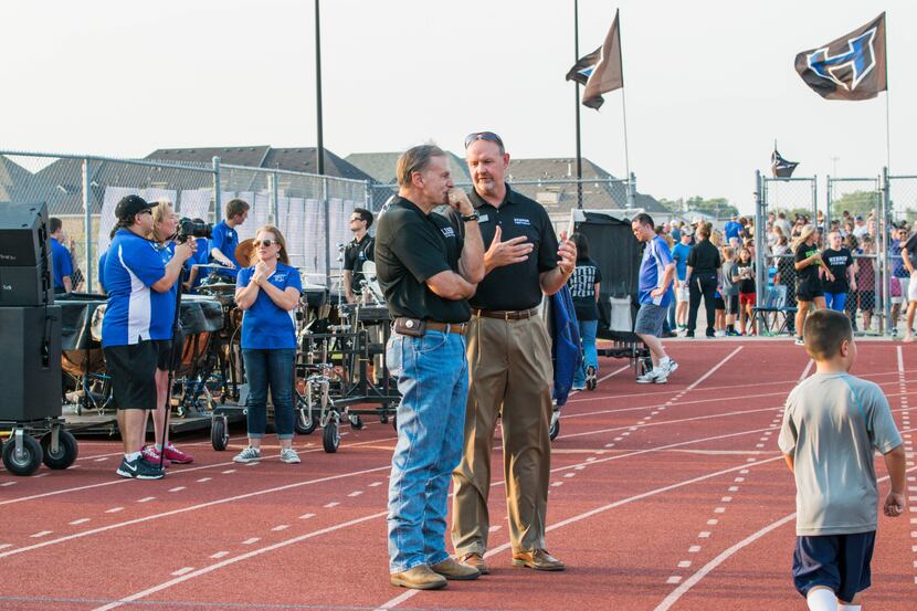 Lewisville ISD athletic director Tim Ford (left) talks to former Hebron principal Scot Finch...