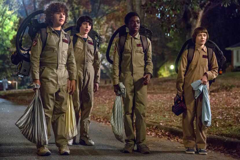 This image released by Netflix shows Gaten Matarazzo, from left, Finn Wolfhard, Caleb...