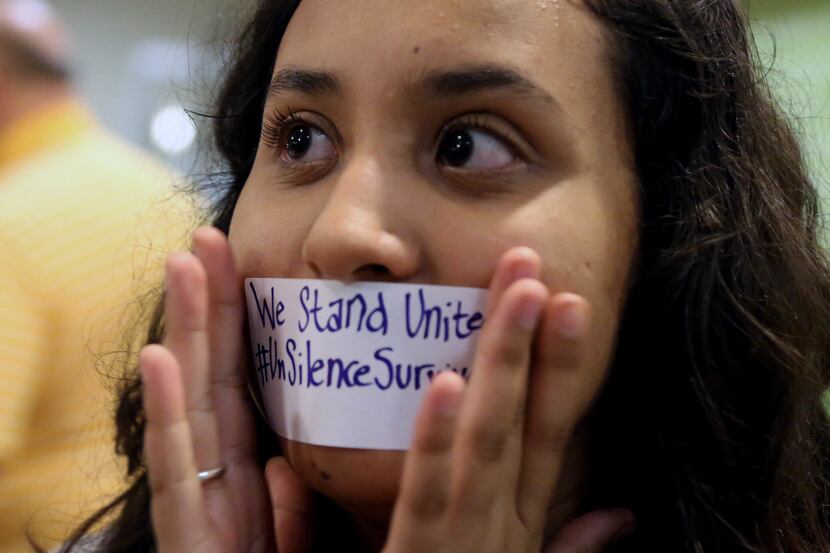 Baylor junior Julieth Reyes cover her mouth with tape during a rally a rally of current and...
