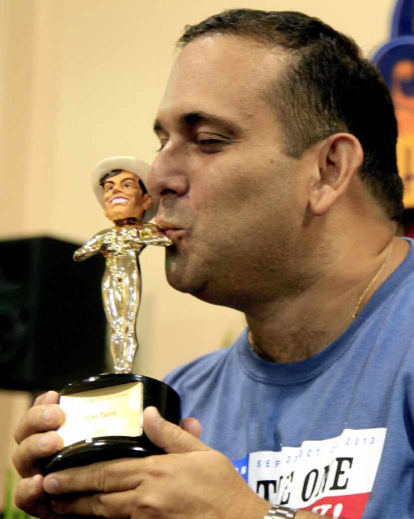 Isaac Rousso kisses his trophy after winning best taste at the Big Tex Choice Awards with...