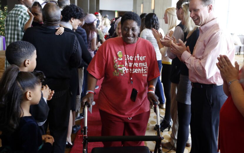 Carol "Mama" Hawkins, 58, walks the red carpet with other homeless people as volunteers...