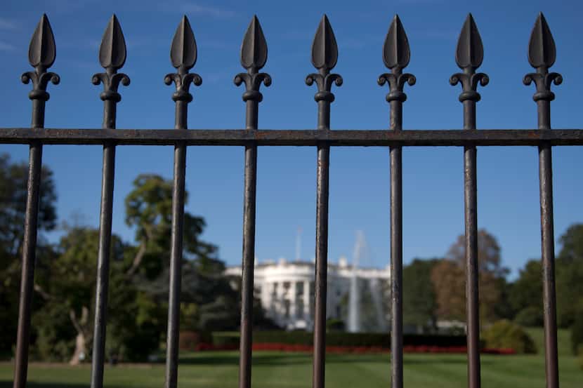 In this Sept. 22, 2014 file photo, the iron perimeter fence lines the South Lawn of the...