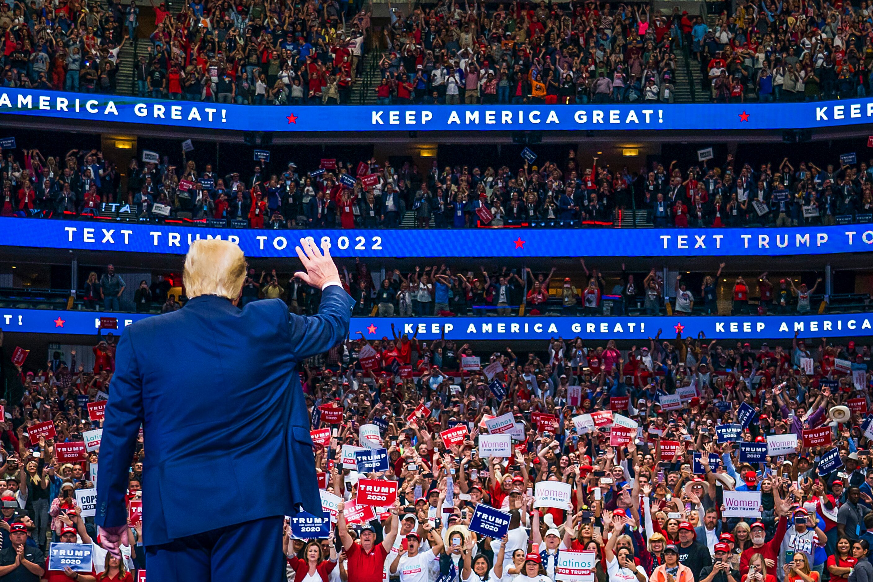 President Donald Trump waves to the crowd as he arrives for a campaign rally at the American...