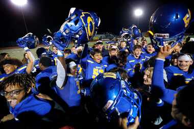 The Community High football team and students celebrate their win over Dallas Roosevelt at...