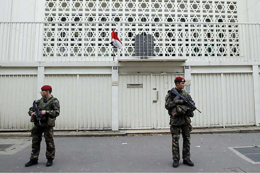 Soldiers guard a Jewish school Monday in Paris after France announced an unprecedented...