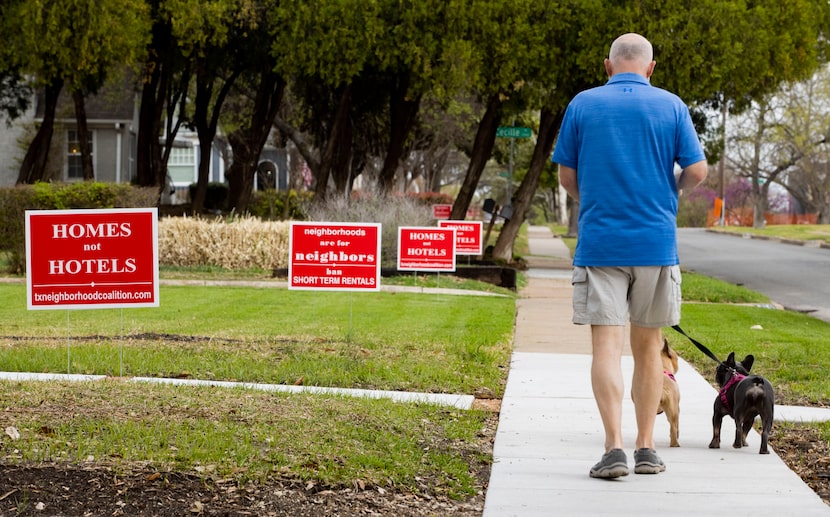 Dale Harwell walks his dogs Nellie and Sophie along Prospect Avenue in Dallas' Edgemont Park...