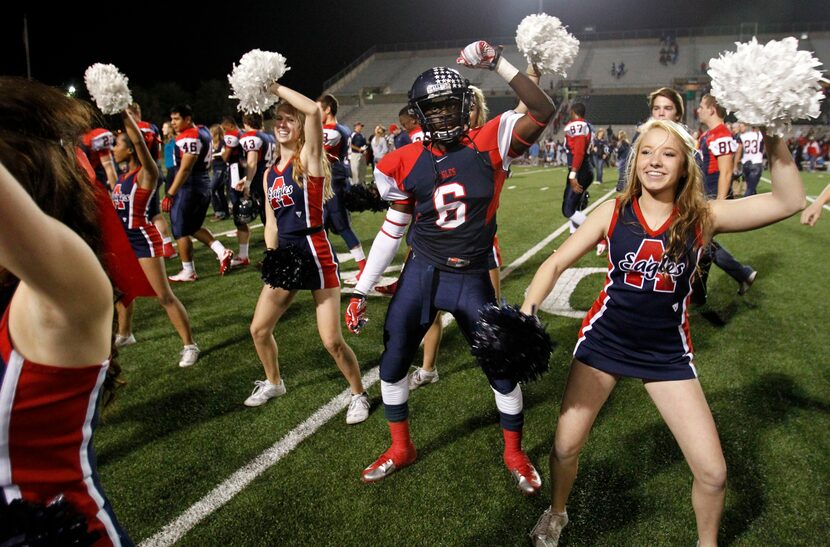 Allen's Kendall Clinton (6) dances with the cheerleaders after they defeated Skyline in the...