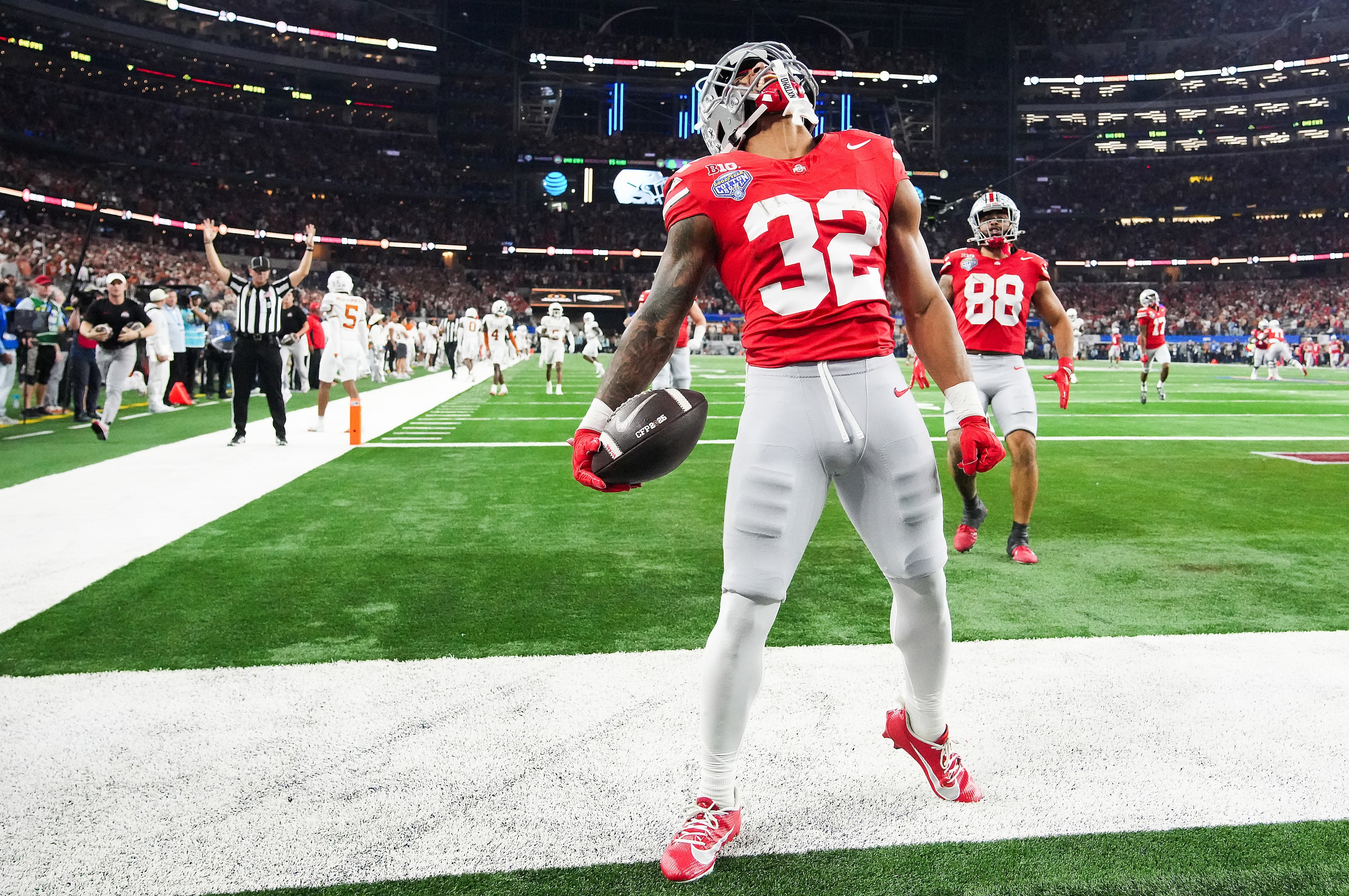 Ohio State running back TreVeyon Henderson (32) celebrates after scoring on a 75-yard...