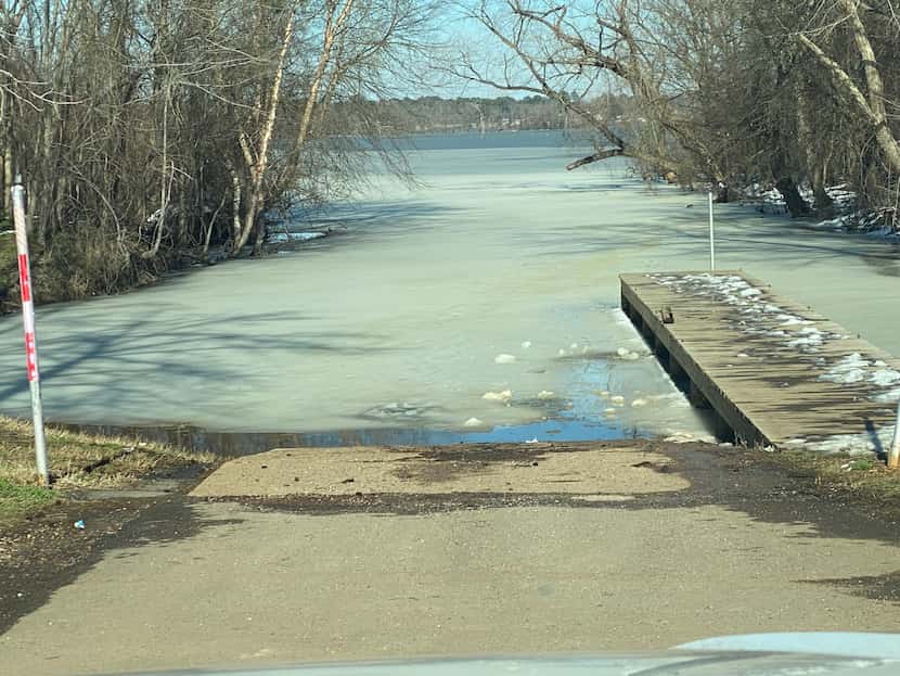 A boat ramp at the upper reaches of Lake Palestine is flanked by a sheet of ice after snow,...