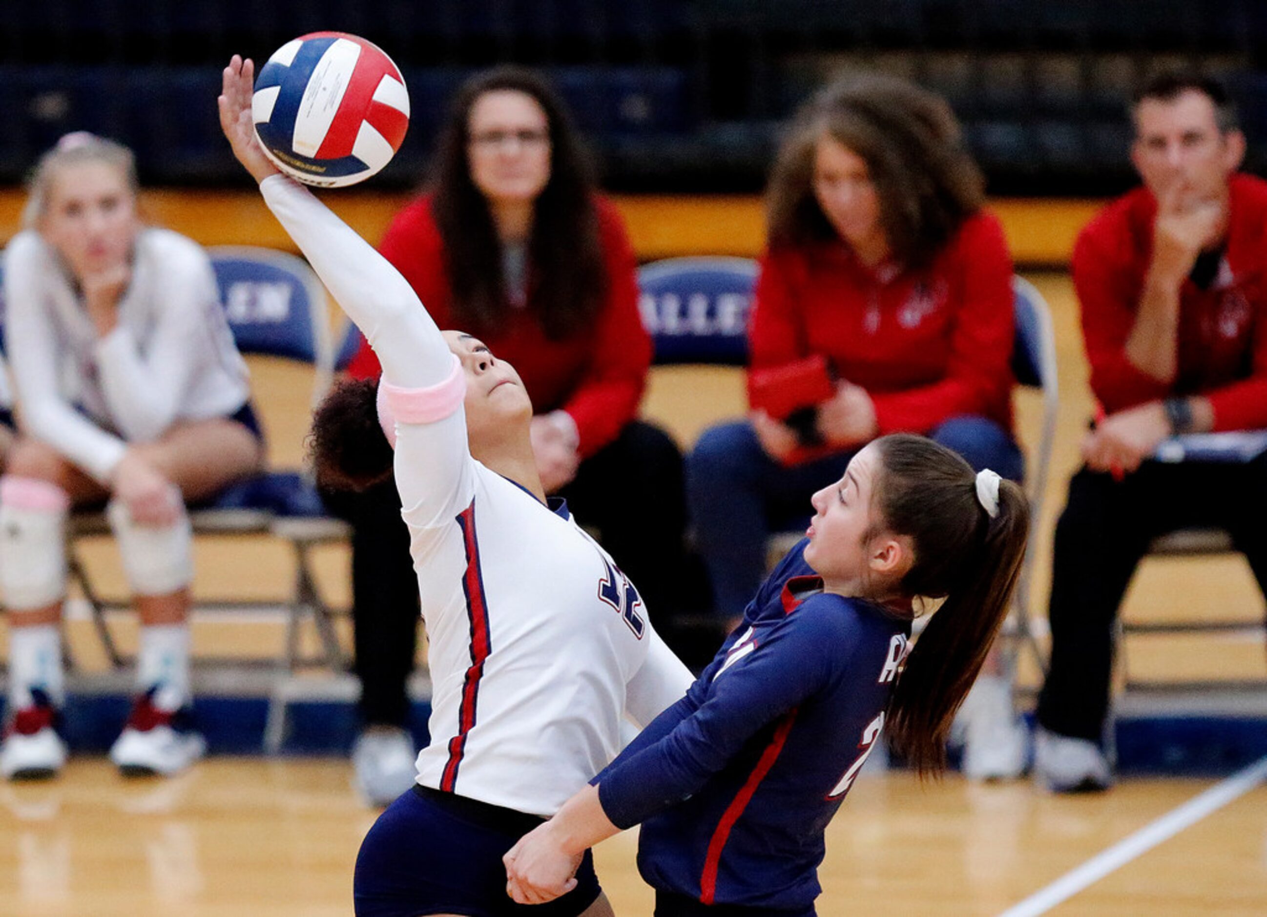 Allen High Schoolâs Maya Detwiler (12) hits the ball as Allen High School libero Emily...