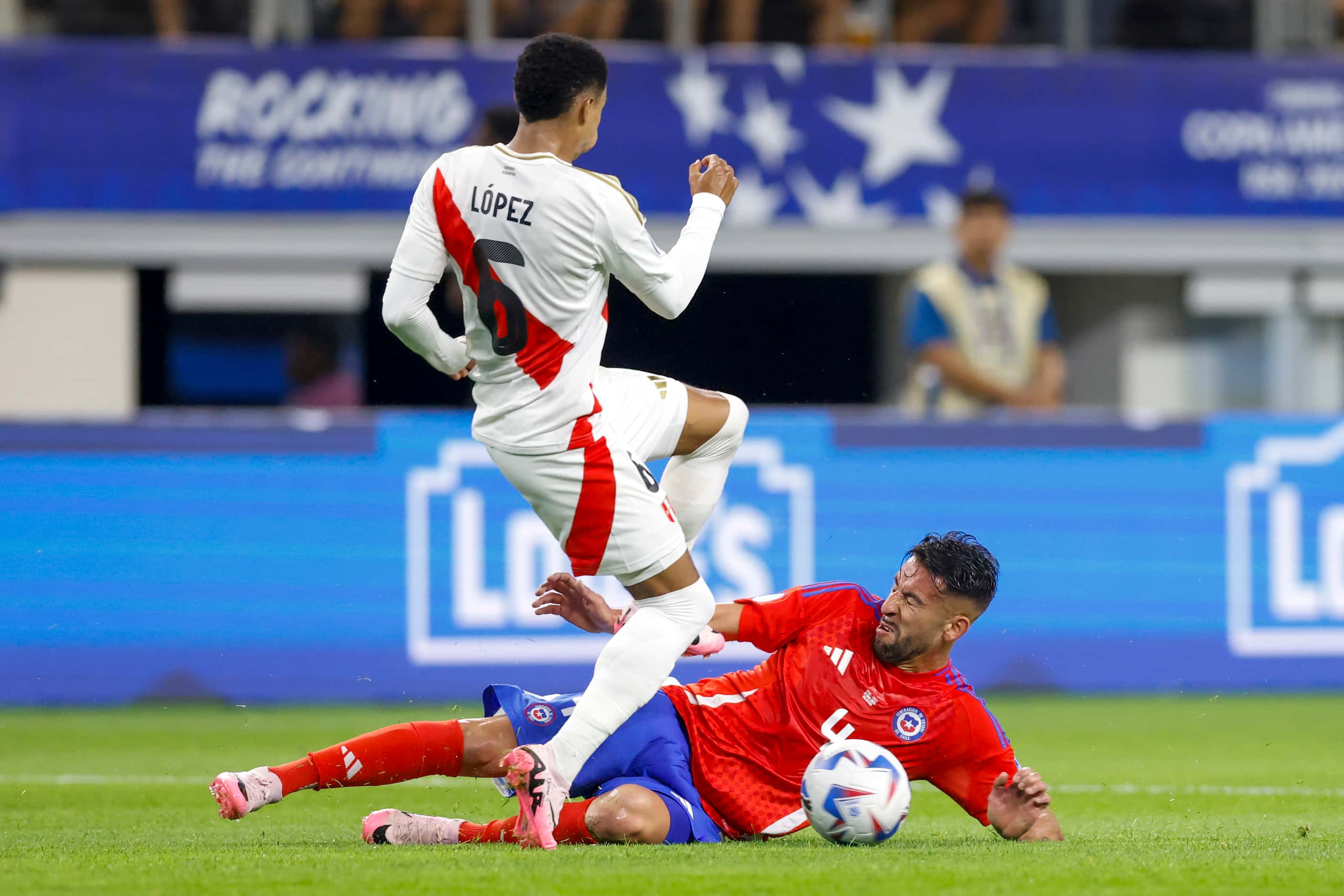Chile defender Mauricio Isla (4) tackles the ball away form Peru defender Marcos López (6)...