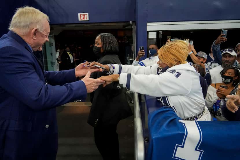 Dallas Cowboys owner and general manager Jerry Jones reaches out to fan Carolyn Price before...