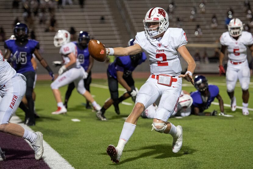 Grapevine Faith quarterback Deuce Hogan (2) extends the ball towards the goal line on a...