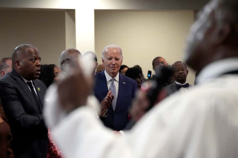 President Joe Biden stands among attendees as Reverend Dr. Jamey O. Graham Sr. speaks at a...