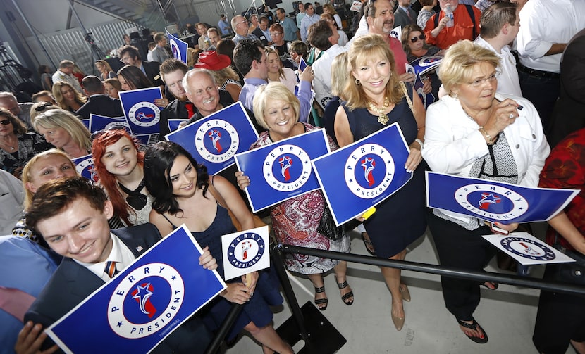 Supporters of former Texas Gov. Rick Perry wait for his arrival on June 4, 2015 in Addison,...