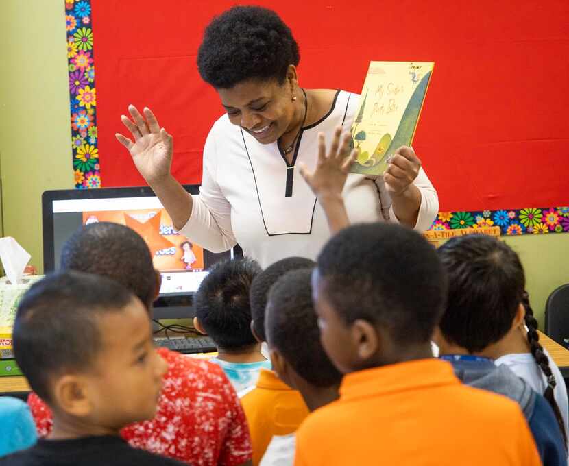 Peggy Cooper chats with her class after reading a book during DISD's refugee summer program...