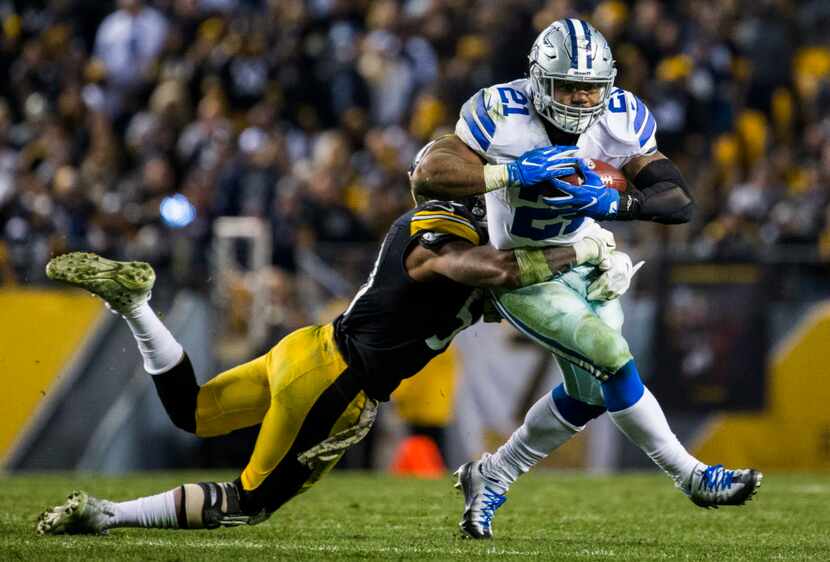 Dallas Cowboys running back Ezekiel Elliott (21) is tackled by Pittsburgh Steelers inside...
