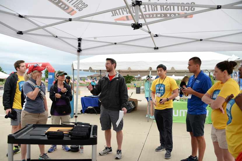 Organizers and staff discuss emergency protocol ahead of a recent North Texas Kids Triathlon.