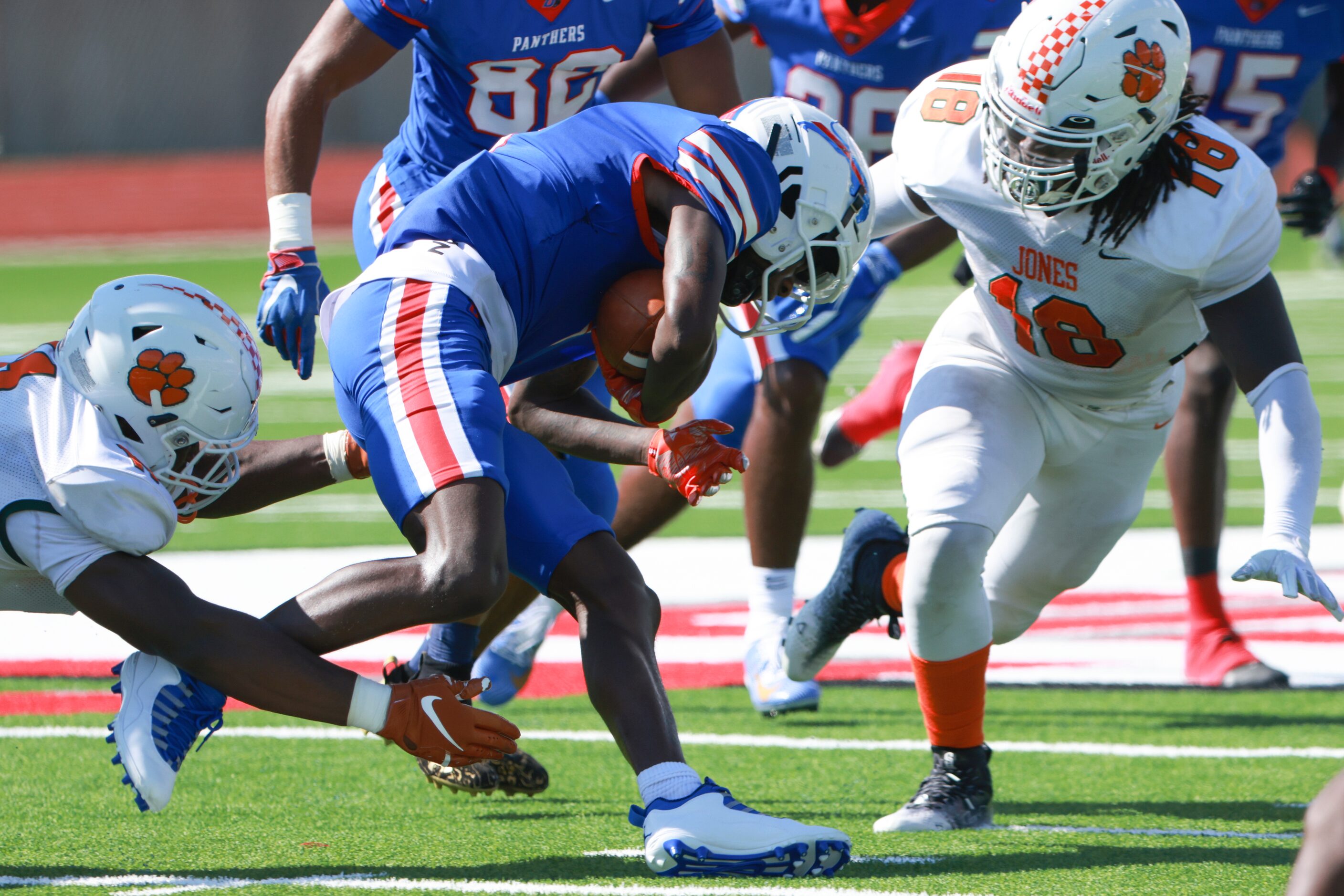 Jones High School Moses Ezechi (11) and DJ McCray (18) block Lamoderick Spencer (3) from...