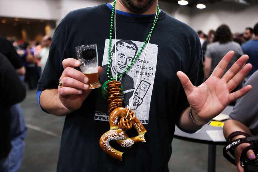 Josh Betts wears a collection of beer snacks while browsing vendors at the2013 version of...