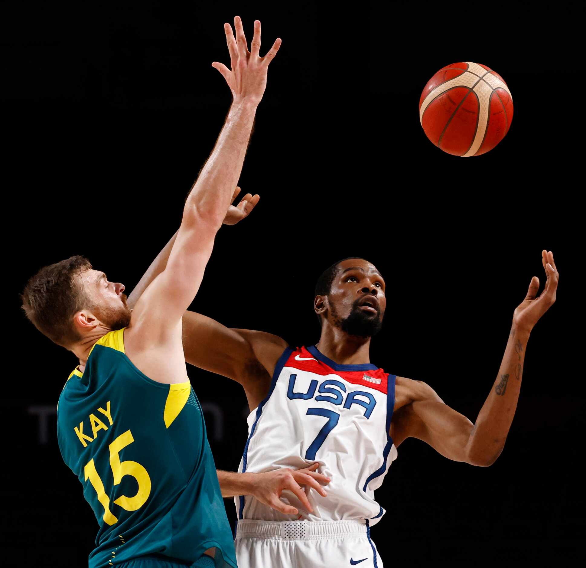USA’s Kevin Durant (7) attempts to gain control of the ball as he is defended by Australia’s...