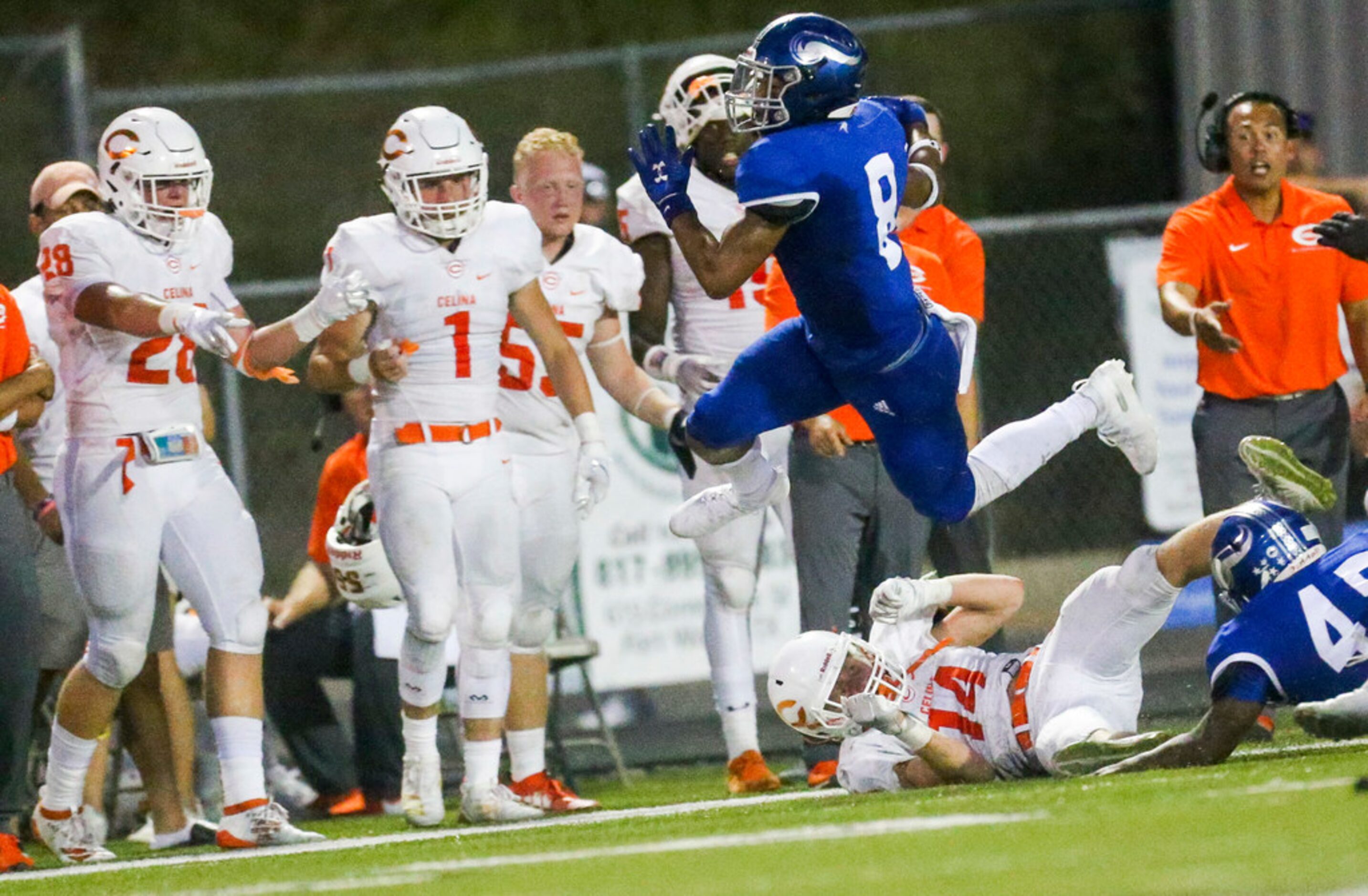 Nolan Catholic defensive back Spencer Roof (8) leaps over Celina wide receiver Eric Parker...