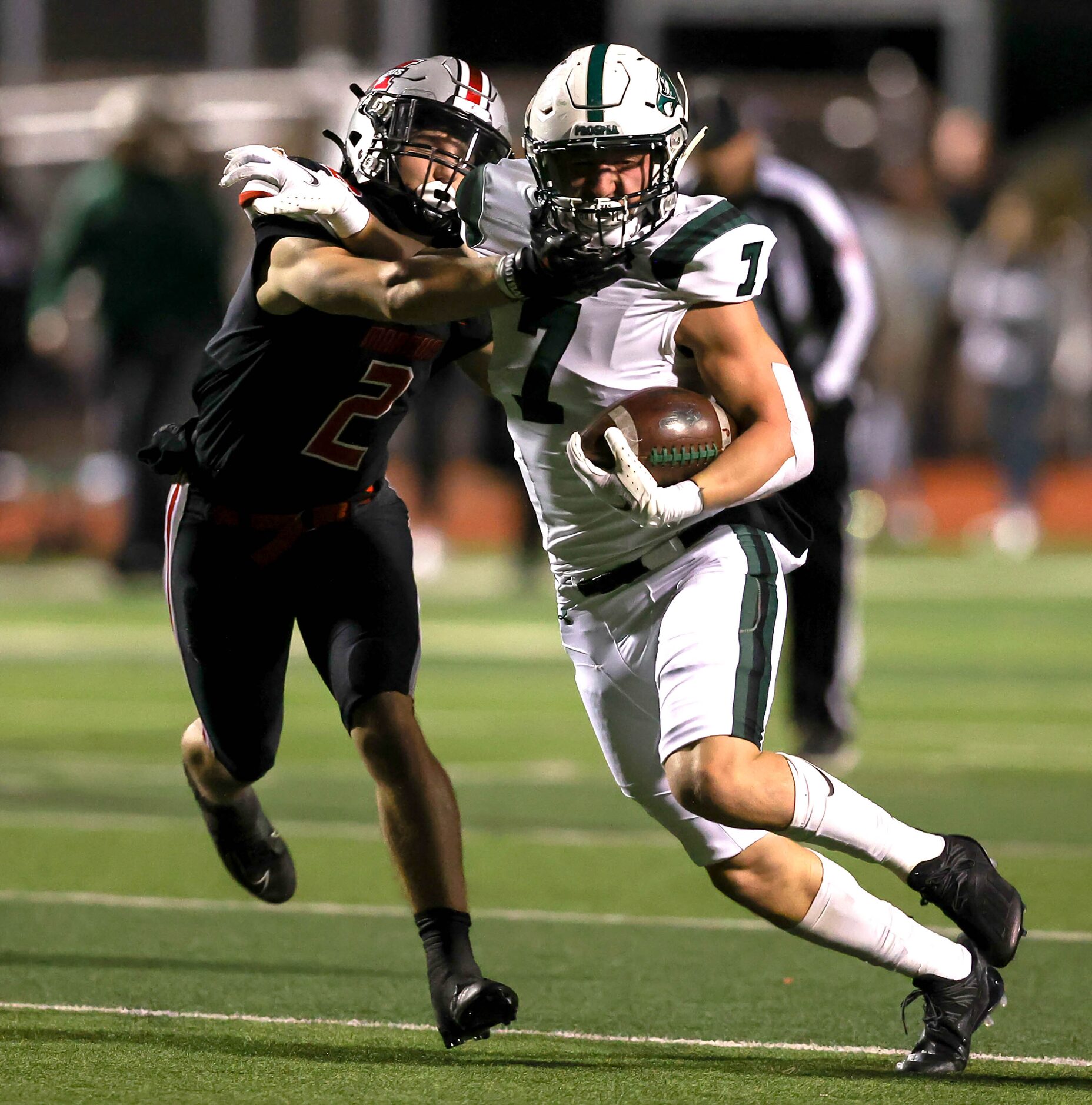 Prosper wide receiver Brayden Rymer (7) fights off a tackle from Flower Mound Marcus...