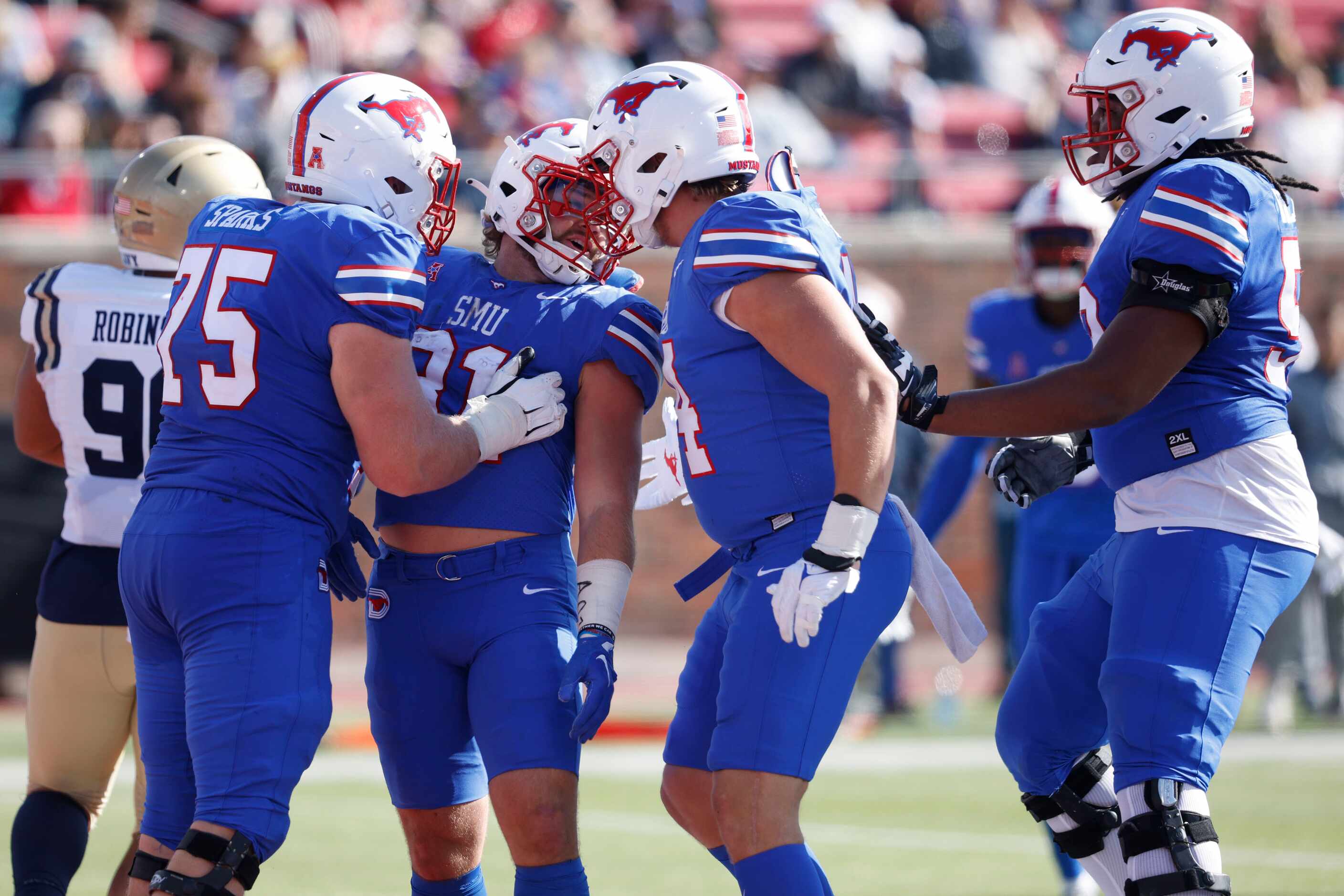 SMU running back Tyler Lavine (31), second from left, celebrates with his teammates after he...