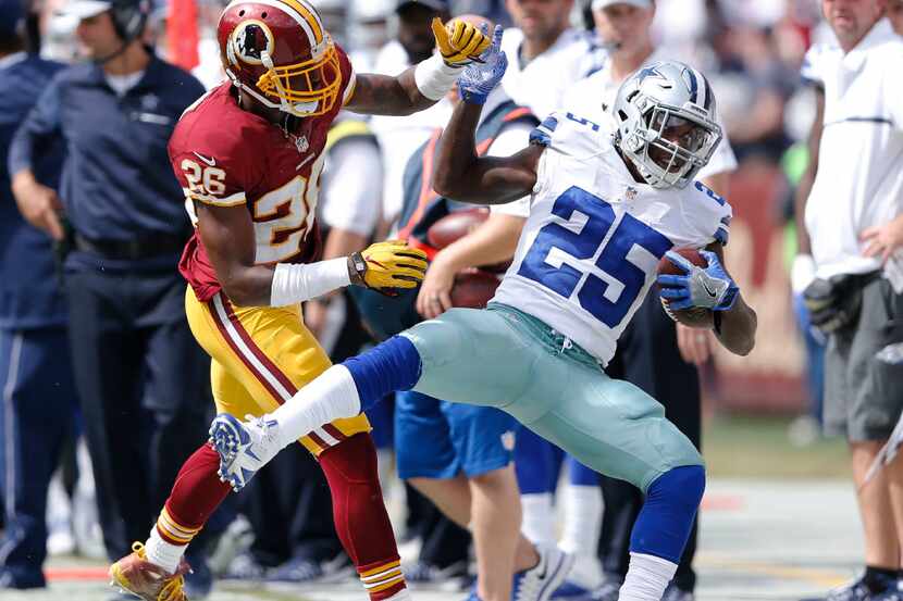 Dallas Cowboys running back Lance Dunbar (25) is pushed out of bounds by Washington Redskins...