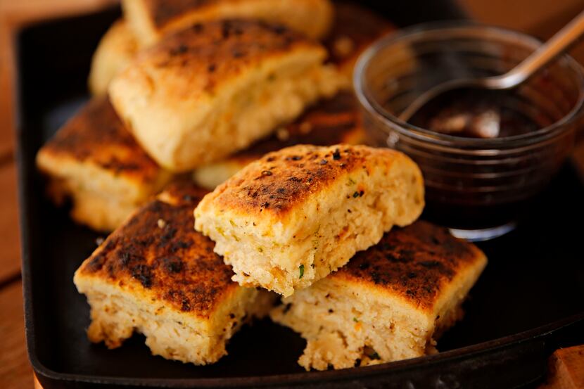 Chef Ken Rathbun's ancho chili-lime biscuits, garnished with a cherry preserve, photographed...