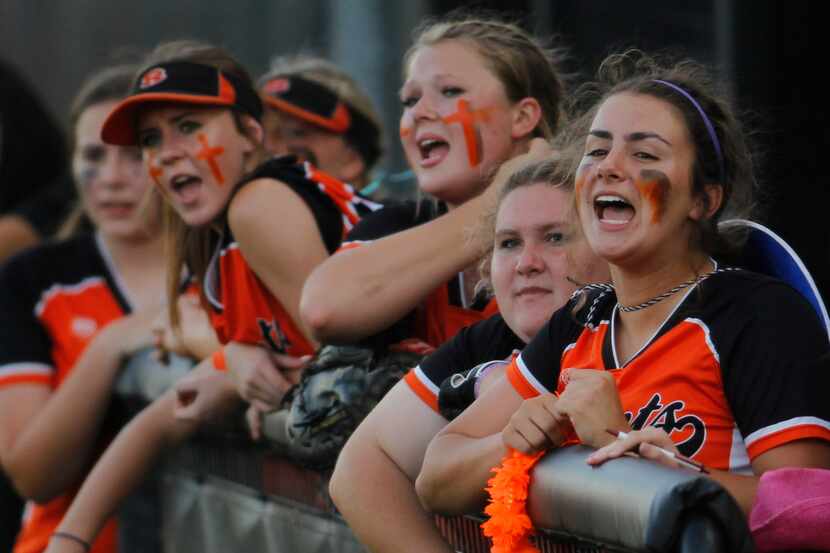Rockwall players vocalize their support from the team dugout during the top of the second...