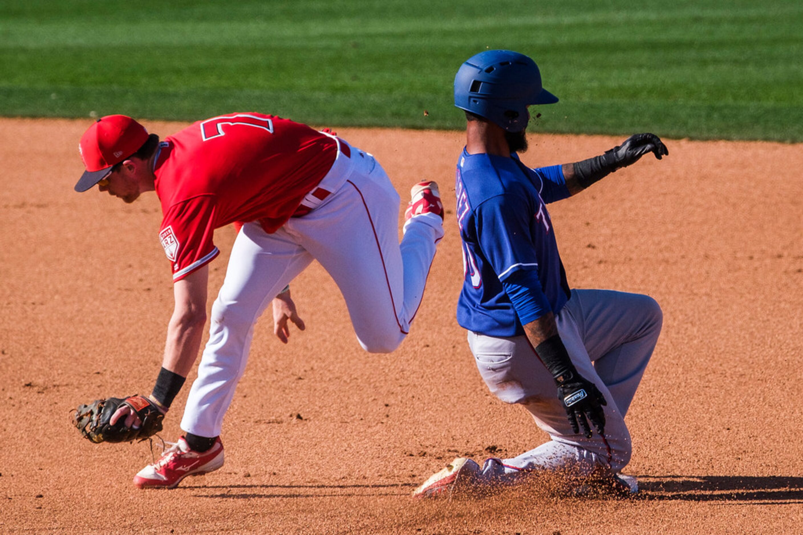 Texas Rangers outfielder Eliezar Alvarez is out at second base as Los Angeles Angels second...