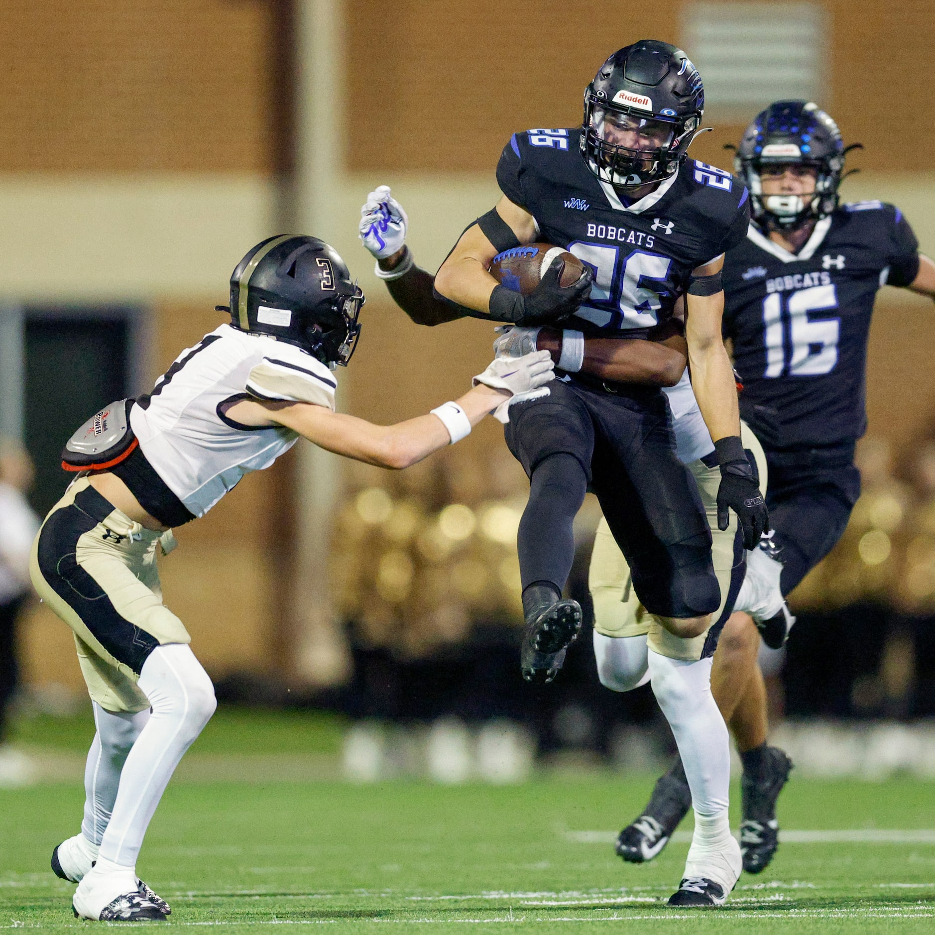 Trophy Club Byron Nelson running back Tucker James (26) jumps to avoid Keller Fossil Ridge...