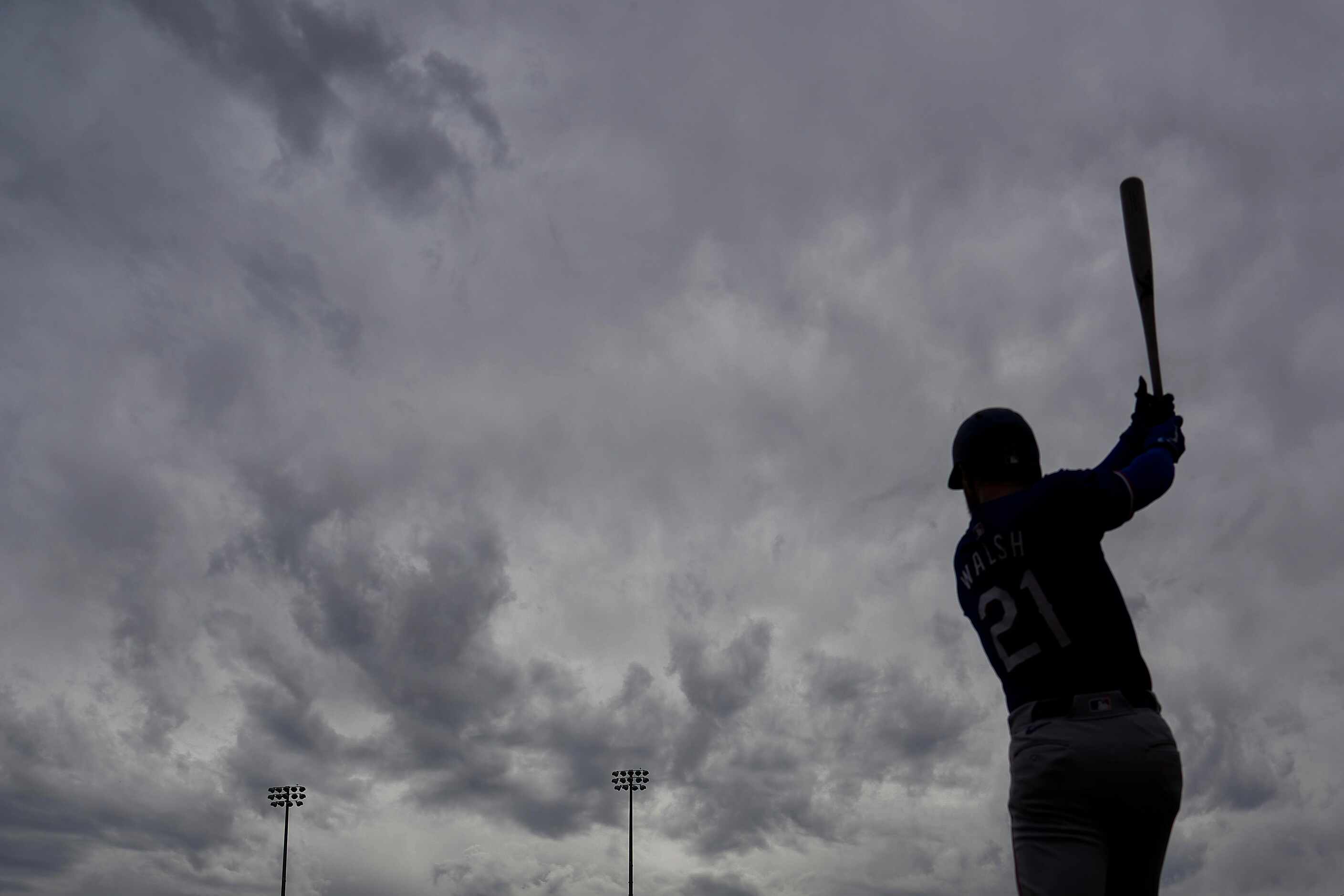 Texas Rangers infielder Jared Walsh takes a warmup swing before a spring training game...