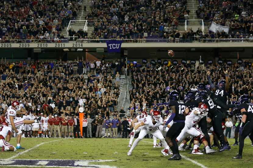 Oklahoma kicker Austin Seibert (43) kicks a field goal next to holder Connor McGinnis (3)...