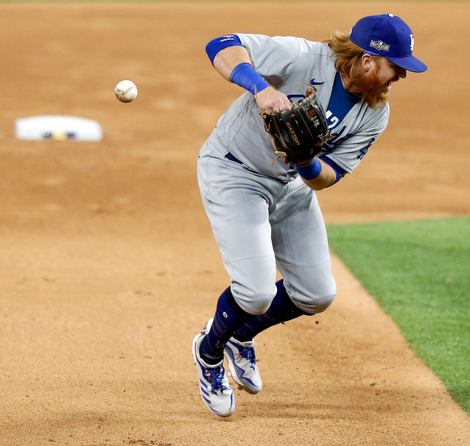 Los Angeles Dodgers designated hitter Justin Turner (10) can't handle a grounder by Atlanta...